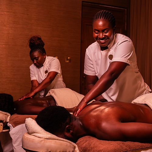 Spa therapists performing relaxing back massage