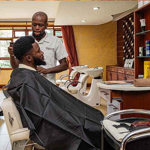Barber grooming a man with haircut at Enashipai Resort