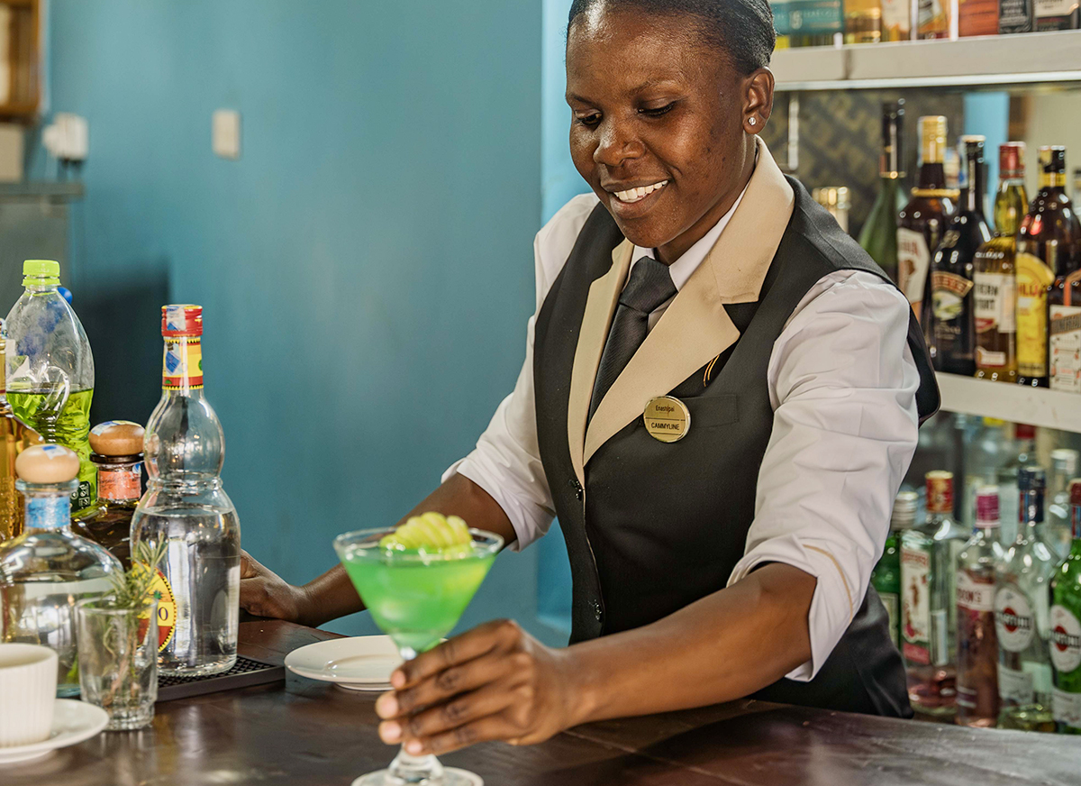 Bartender serving a cocktail at Lakeside Bar