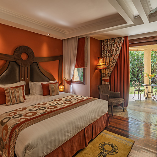 Luxury resort bedroom with king-sized bed and balcony view at Enashipai Resort and Spa